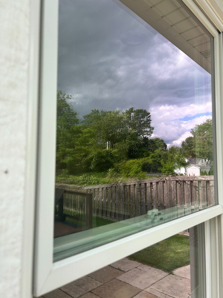 Same home with clean reflective window glass after service